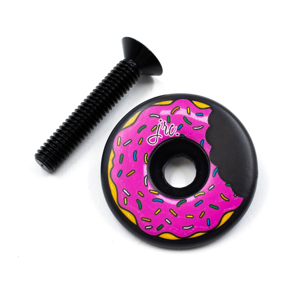 Lightweight, carbon fibre Ahead bicycle stem top cap with pink doughnut design, UD weave and matt finish