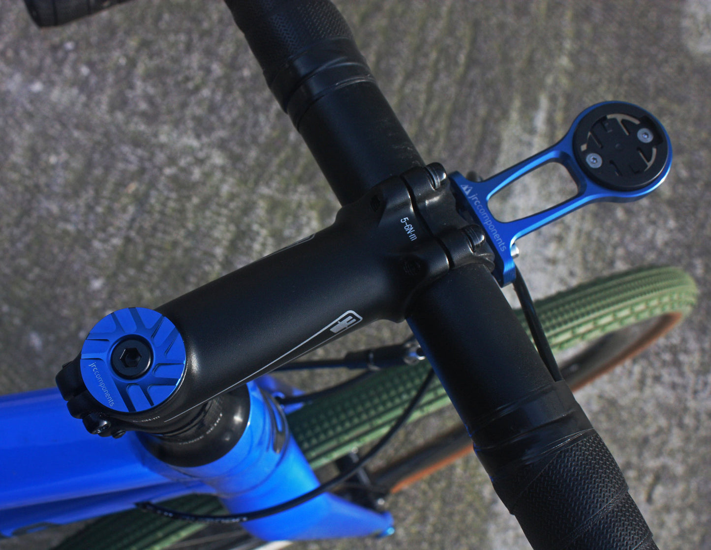 Blue, lightweight, aluminium Ahead stem top cap with sleek pathway design, fitted to bicycle