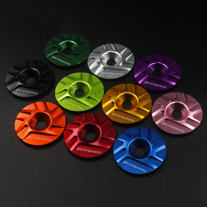 Lightweight, aluminium Ahead stem top cap with sleek pathway design in various colours on black background